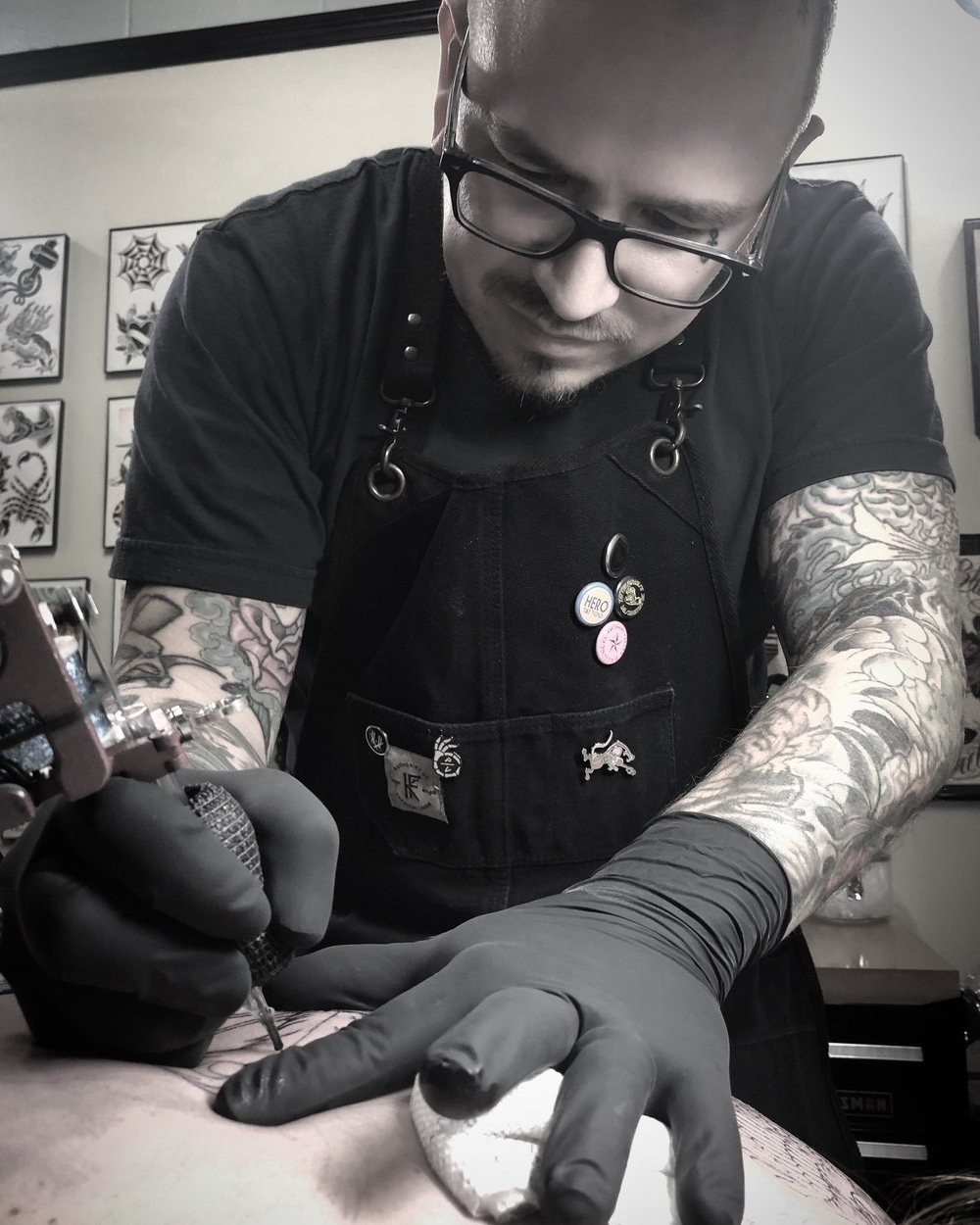 Scott Denhalter at work tattooing a client