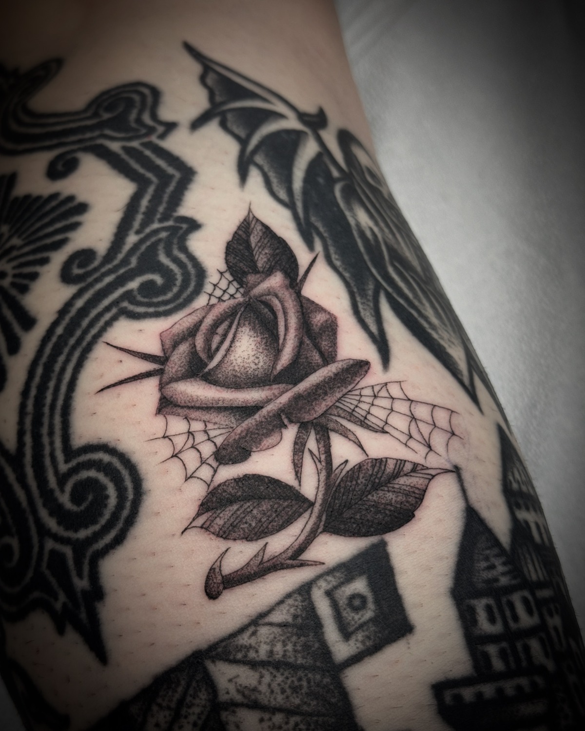 Rose with spiderwebs — tattoo by Scott Denhalter